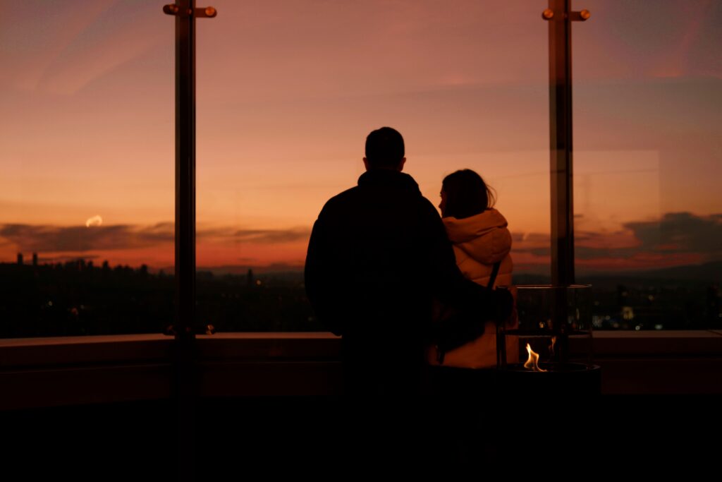 Date Night Ideas: Open This Right Now If You’re Currently Arguing About What to Do Tonight A couple standing together at sunset, escaping the typical decision loop with fresh date night ideas.