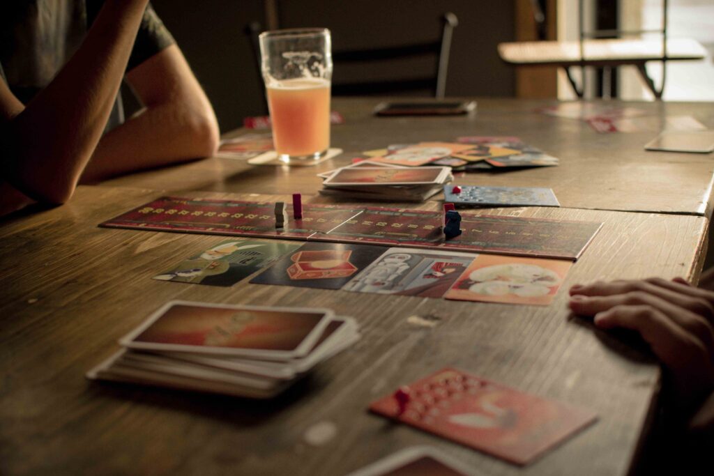A board game laid out on a wooden table at a cafe, ideal for first interactive meetups. 