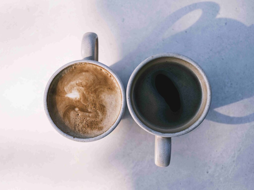 Two coffee cups placed on an outdoor patio table, creating a backdrop for second casual get-togethers.