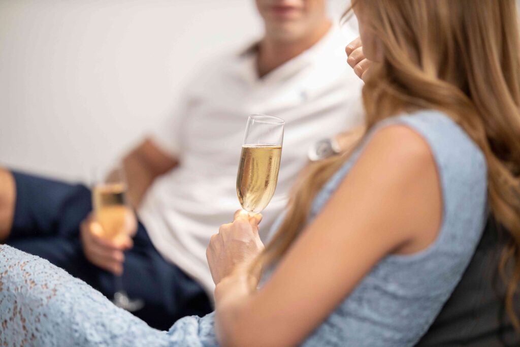 A couple holding glasses of champagne during romantic, creative evening date concepts.