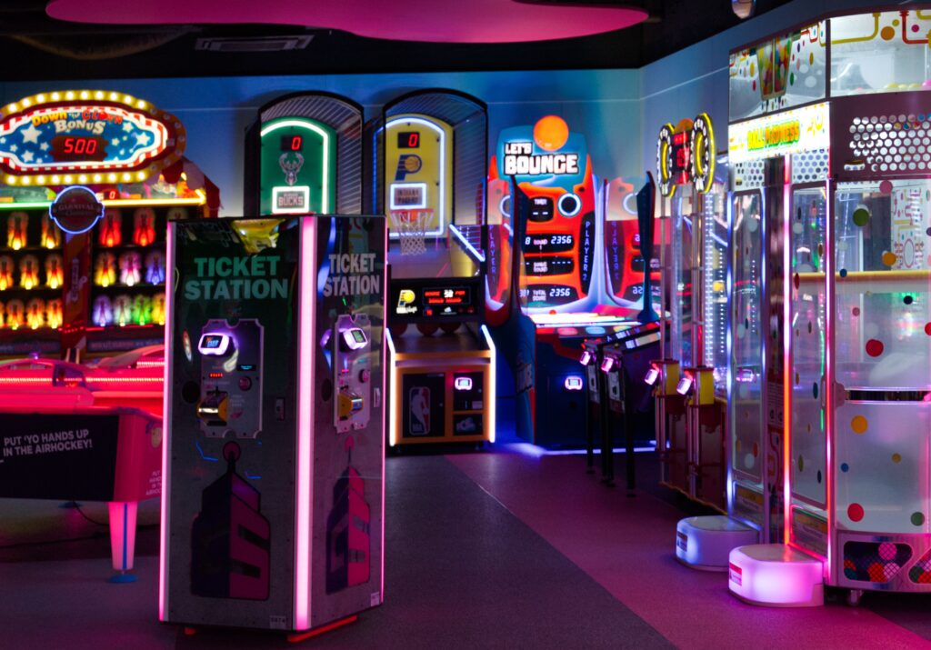 A vibrant retro arcade room filled with neon lights, perfect for playful fun outings.