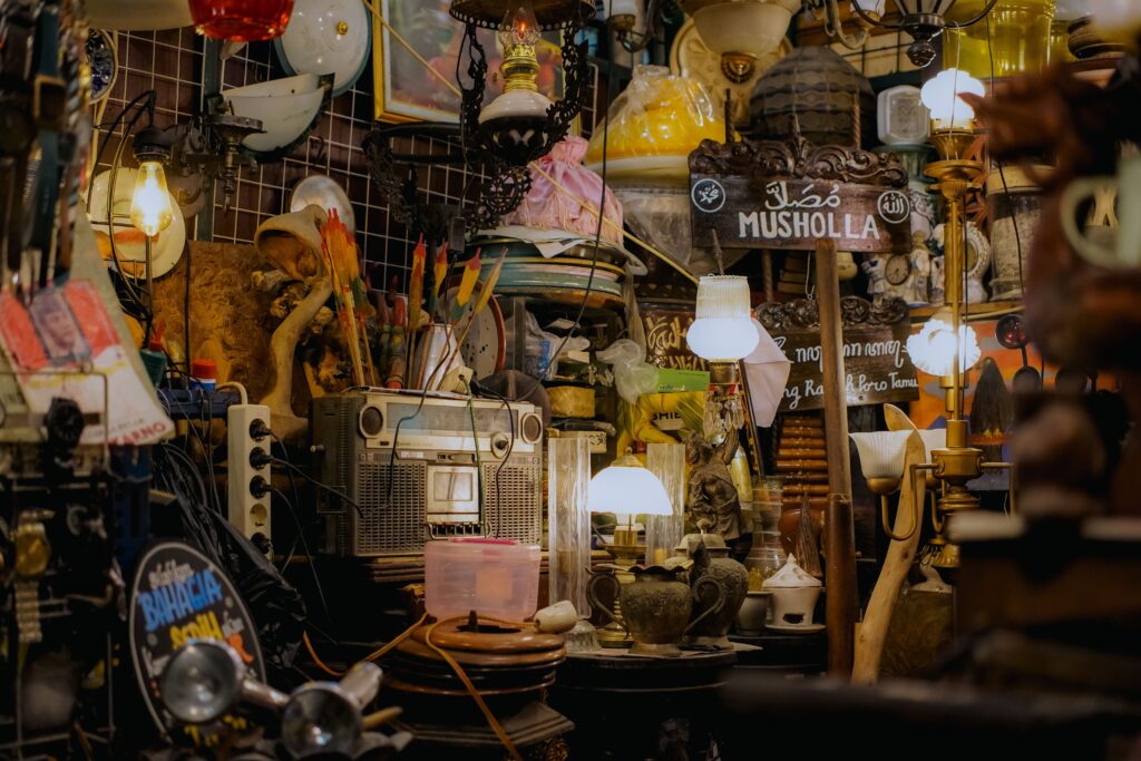 A close up of hands looking through vintage goods at a flea market during playful outings.