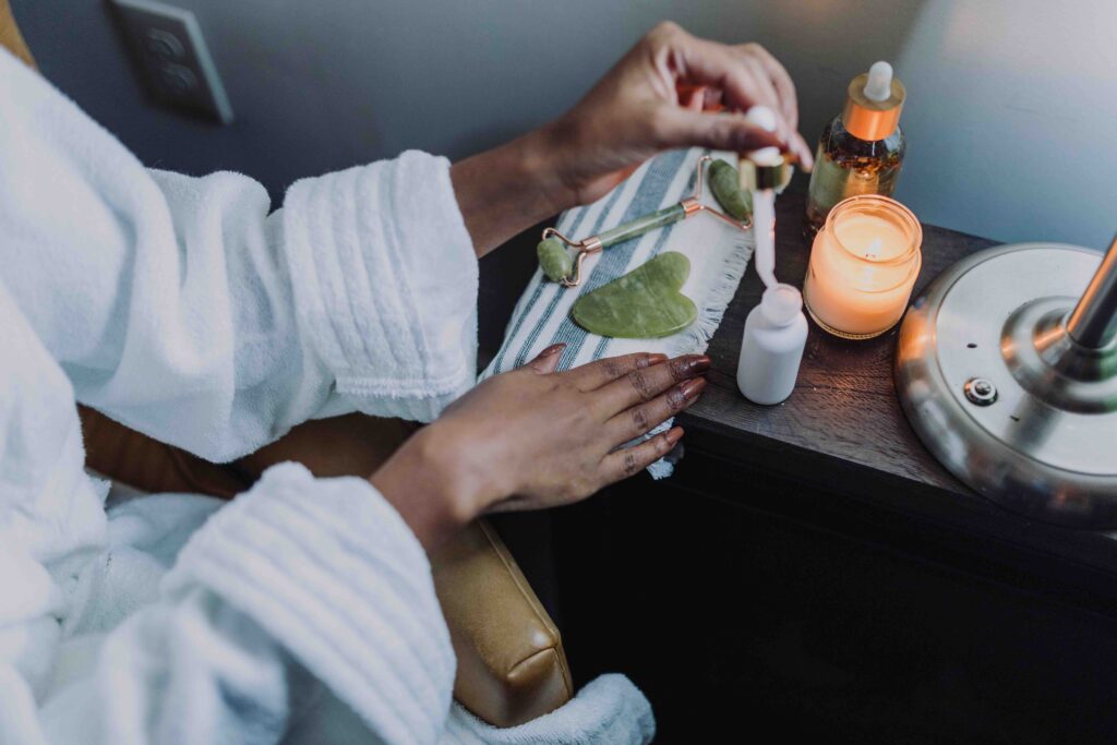 A burning candle on a bedroom nightstand, showing self-care and high relationship expectations.