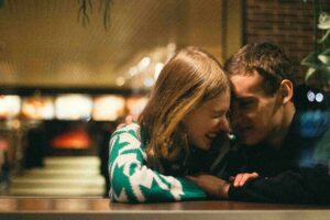 Save These Freaky Rizz Lines for After Midnight When the Small Talk Is Officially Over A cozy couple laughing together, perfect for trying out freaky rizz lines.